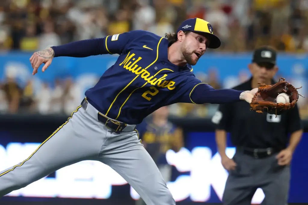 Milwaukee Brewers second baseman Brice Turang catches a foul ball...