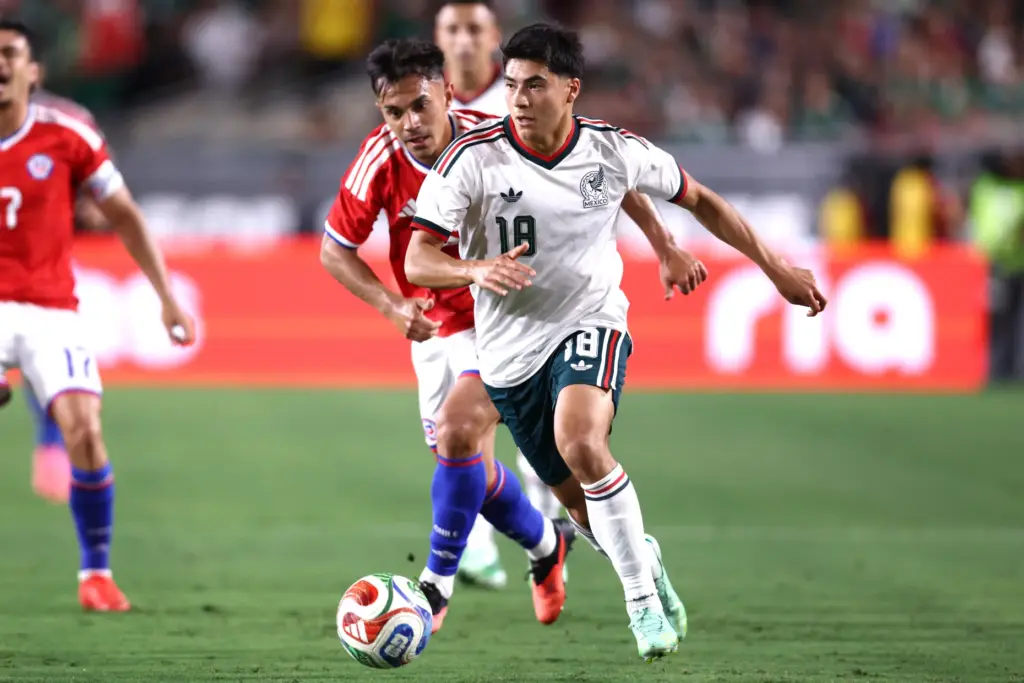 Mexico midfielder Obed Vargas controls the ball while being defended...