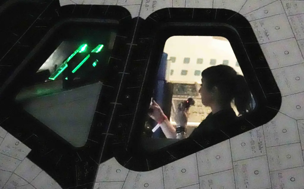 A visitor inside the cockpit of Endeavour on display as...