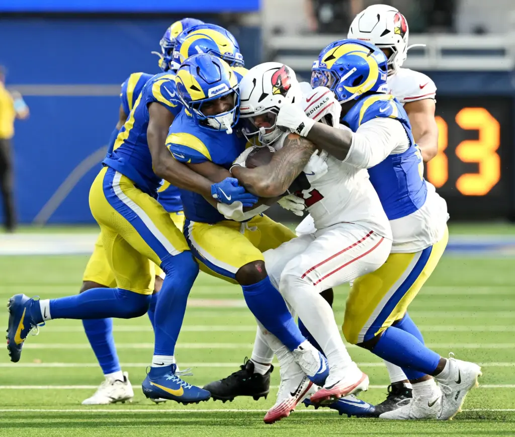 Rams defenders stop Arizona Cardinals running back Tyler Allgeier (22)...