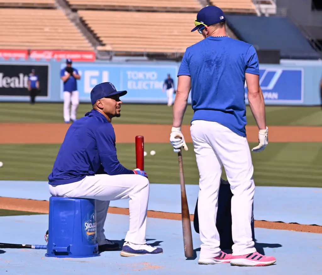 Dodgers shortstop Mookie Betts, left, talks with utility player Kike...