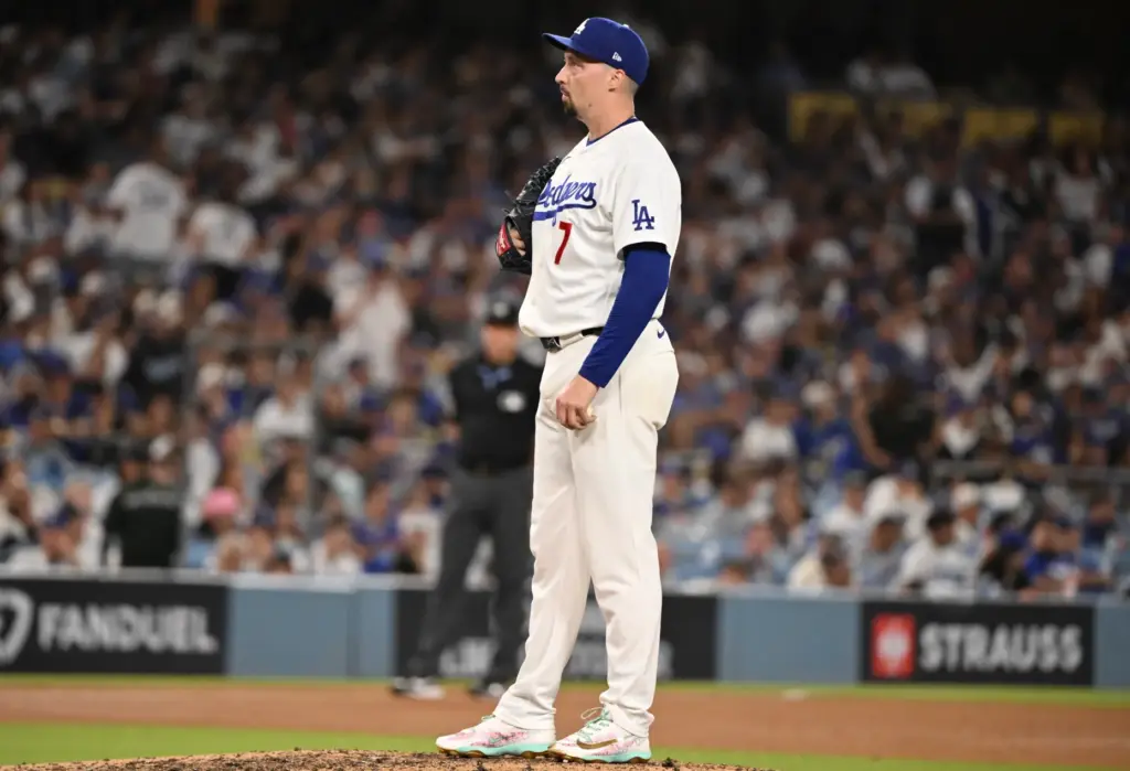 Dodgers starting pitcher Blake Snell looks on after giving up...