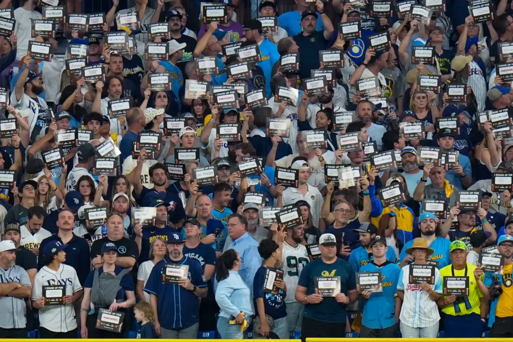 Fans participate in the stand-up to cancer event during the...