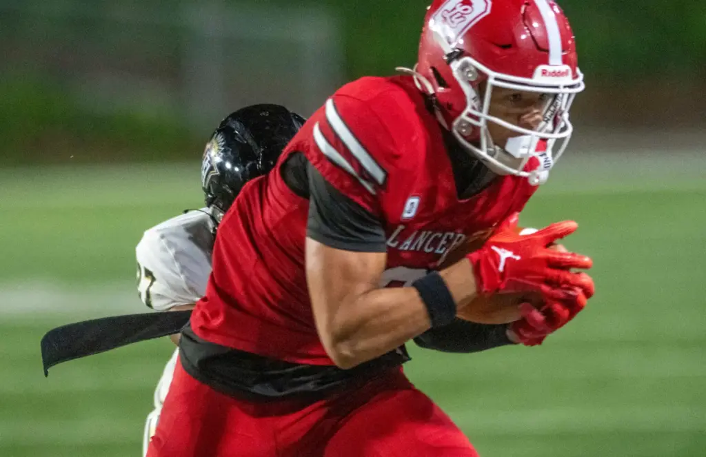 Orange Lutheran’s Hudson Ploog (10) pulls in a first down...