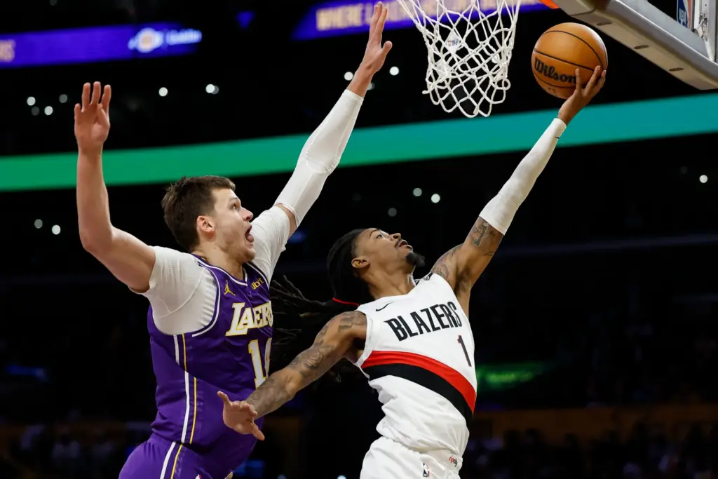 Portland Trail Blazers guard Ja Morant, right, drives to the...