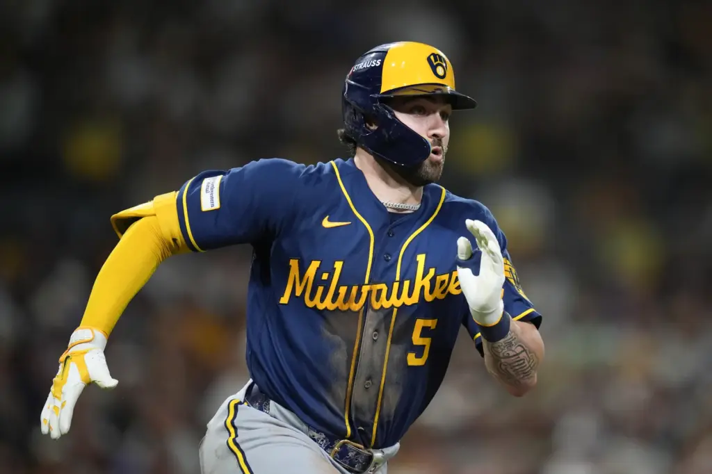 The Milwaukee Brewers’ Garrett Mitchell runs after hitting a triple...