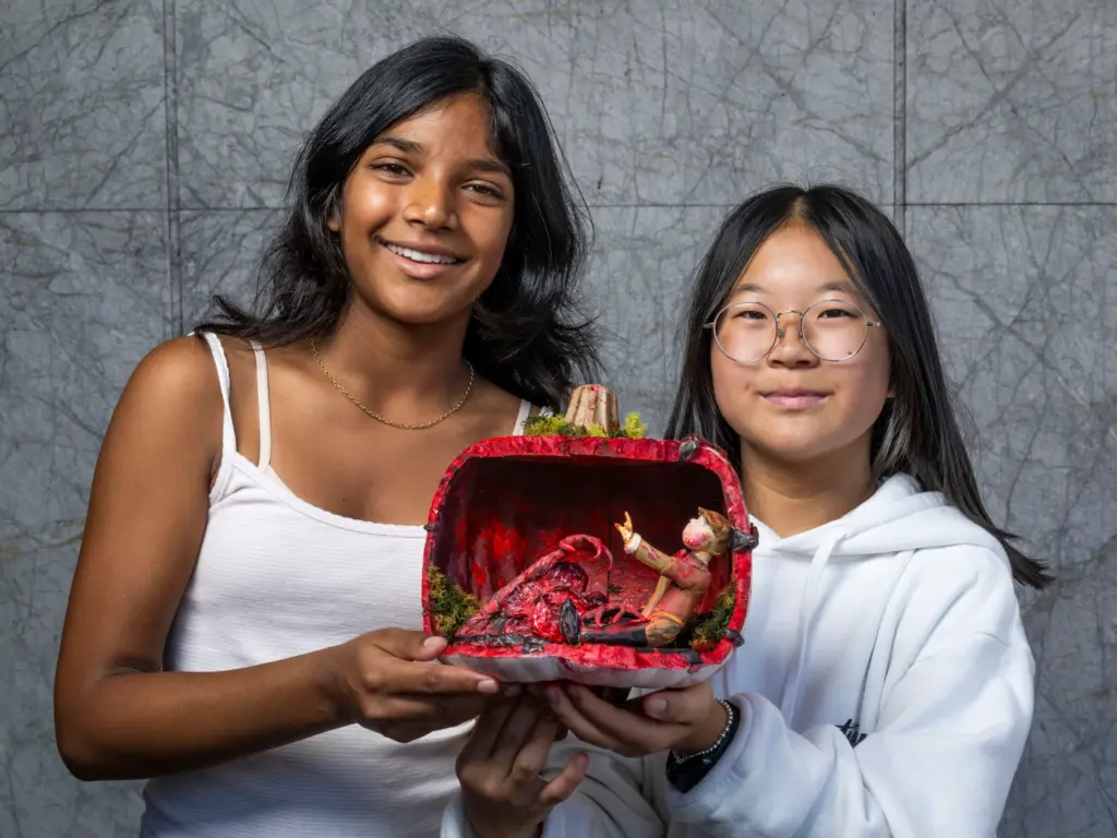 Aashni Puvvada, left, and Stella Park holds their pumpkin titled...