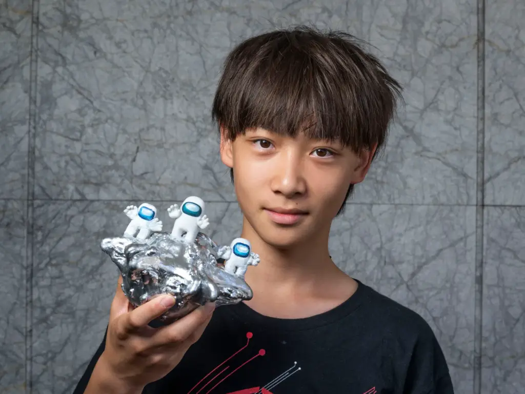 Mason Mei holds his pumpkin titled âPumpkin UFO: Whoâs Among...
