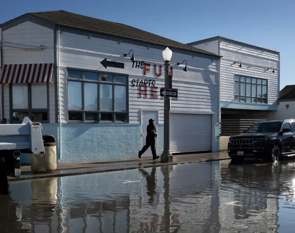 Dozens of workers hustle to help alleviate flooding, including sandbagging...