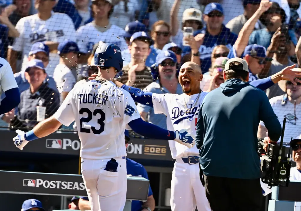 The Dodgers’ Kyle Tucker, left, is greeted by teammate Mookie...