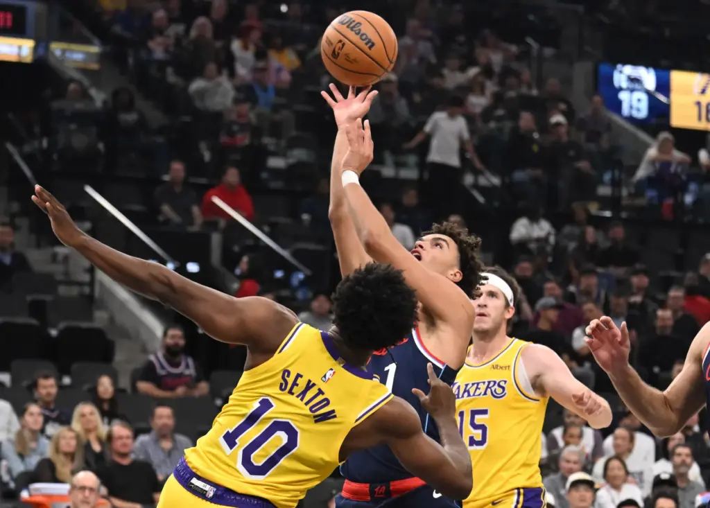 Clippers rookie guard Keaton Wagler, middle, drives to the basket...