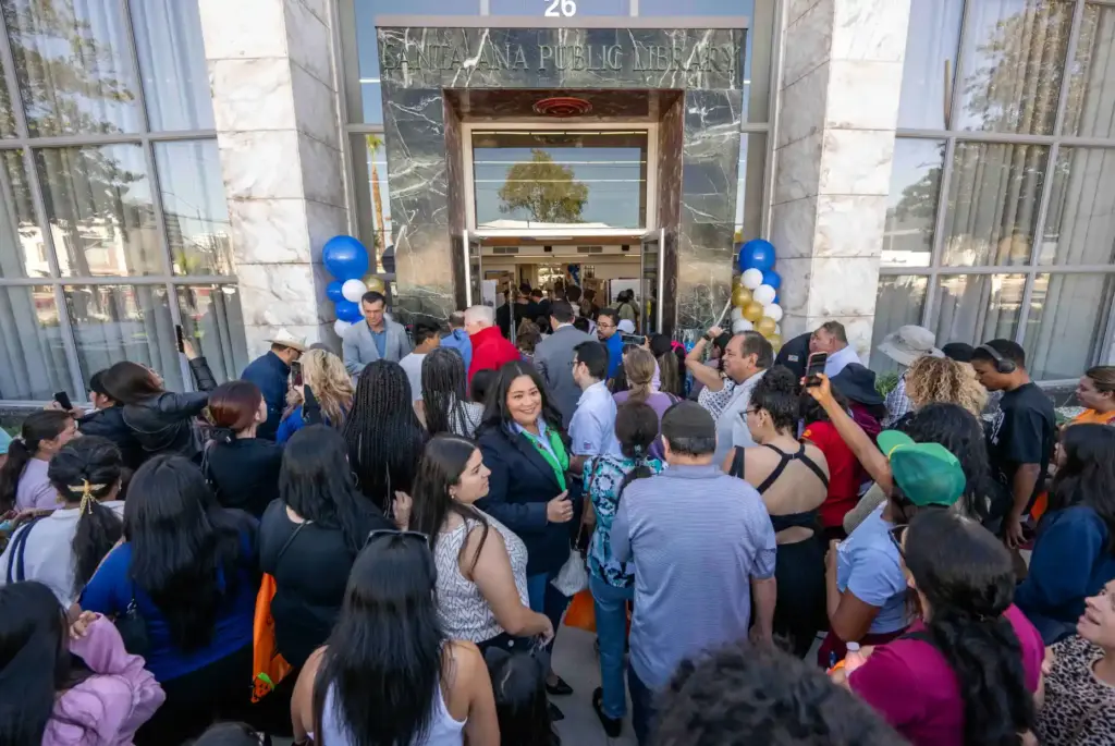 Dozens of residents flood through the entrance to the Santa...