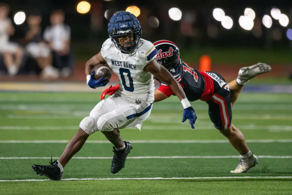 West Ranch High School’s Mesziah Ramos (0) avoids a tackle...