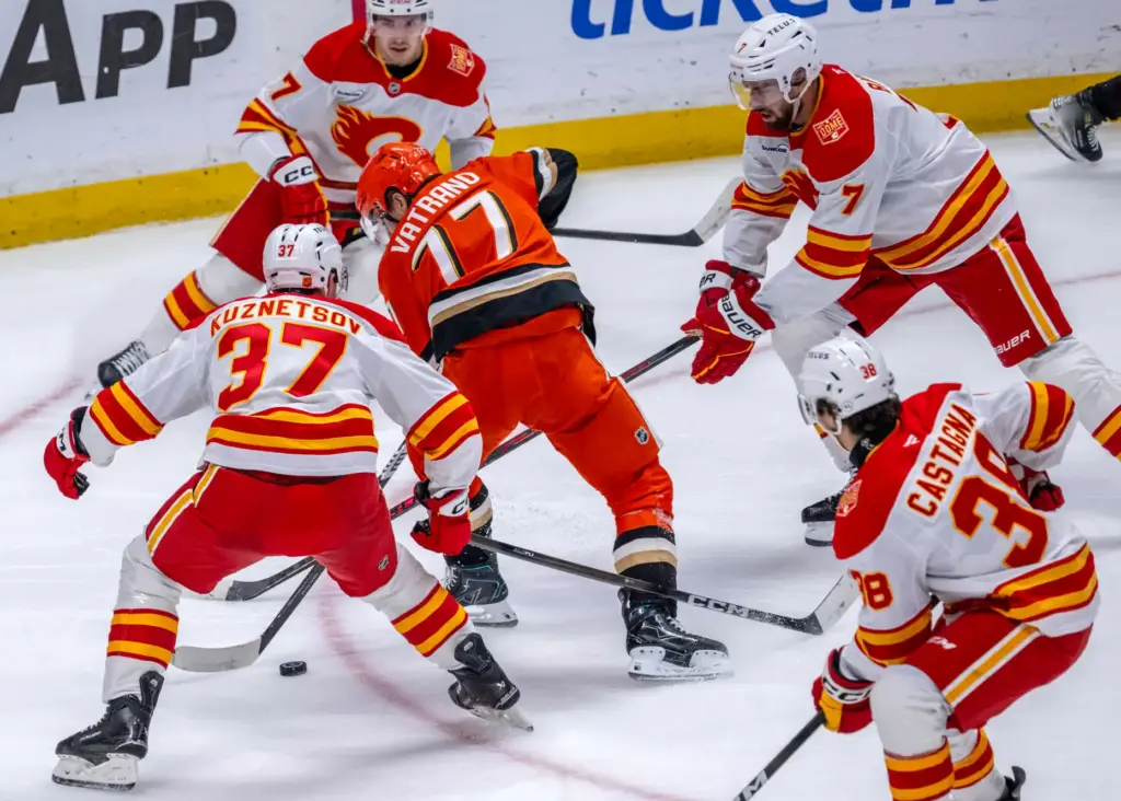 The Ducksâ Frank Vatrano (77) controls the puck while surrounded...