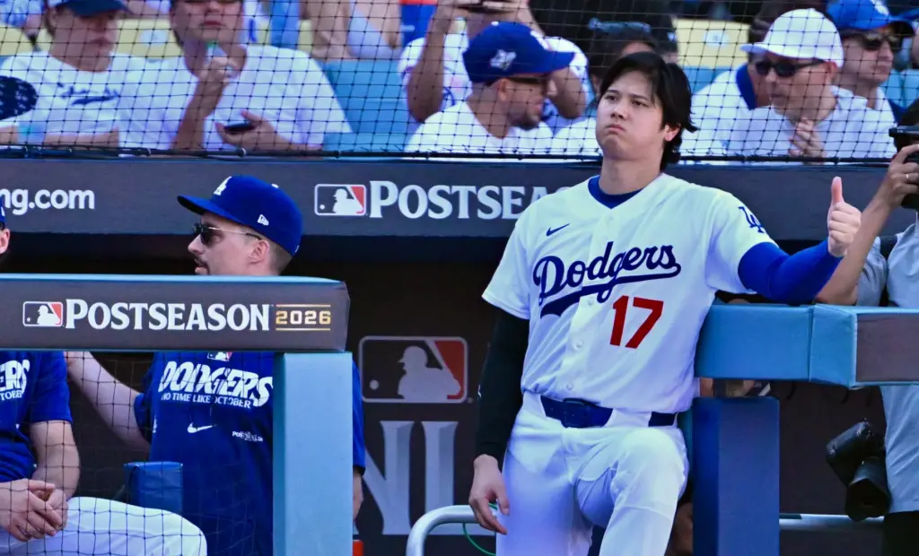 Dodgers star Shohei Ohtani looks on from the dugout during...