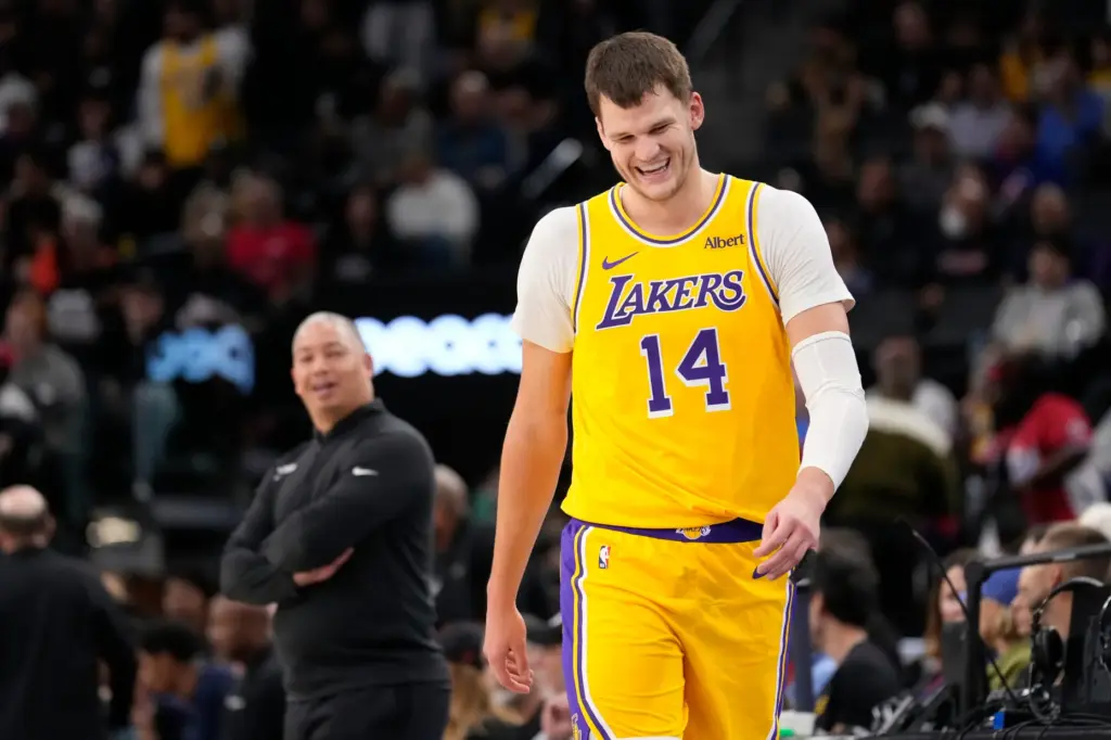 Lakers center Walker Kessler, right, laughs after talking with Clippers...