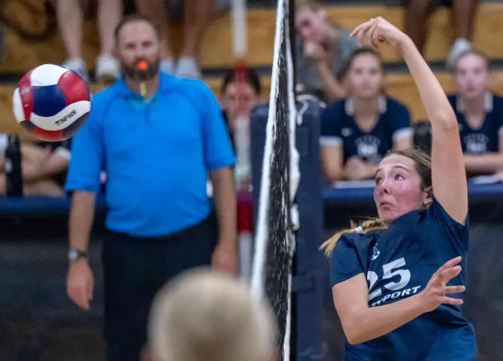 Newport Harbor setter Avery Hansen (25) spikes the ball on...