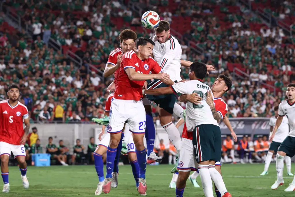 Mexico forward Santiago TomÃ¡s Gimenez, top, heads the ball during...