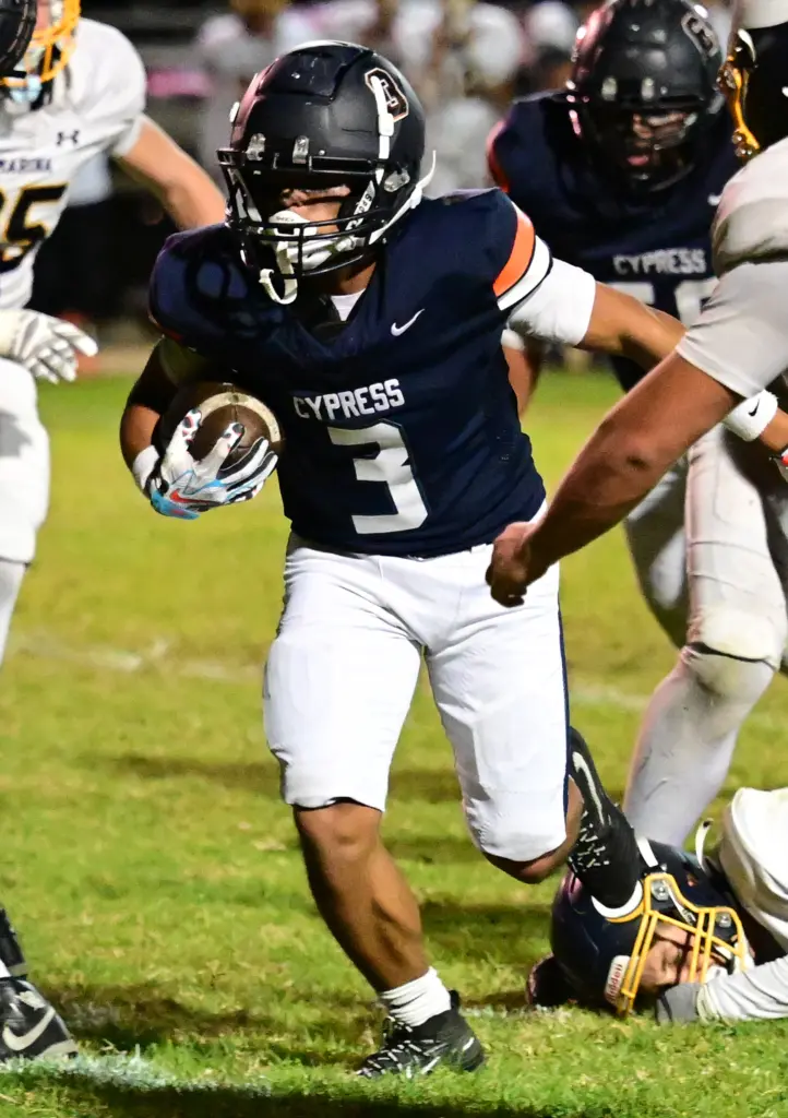 Jayson Bagsic #3 of Cypress runs for a TD in...