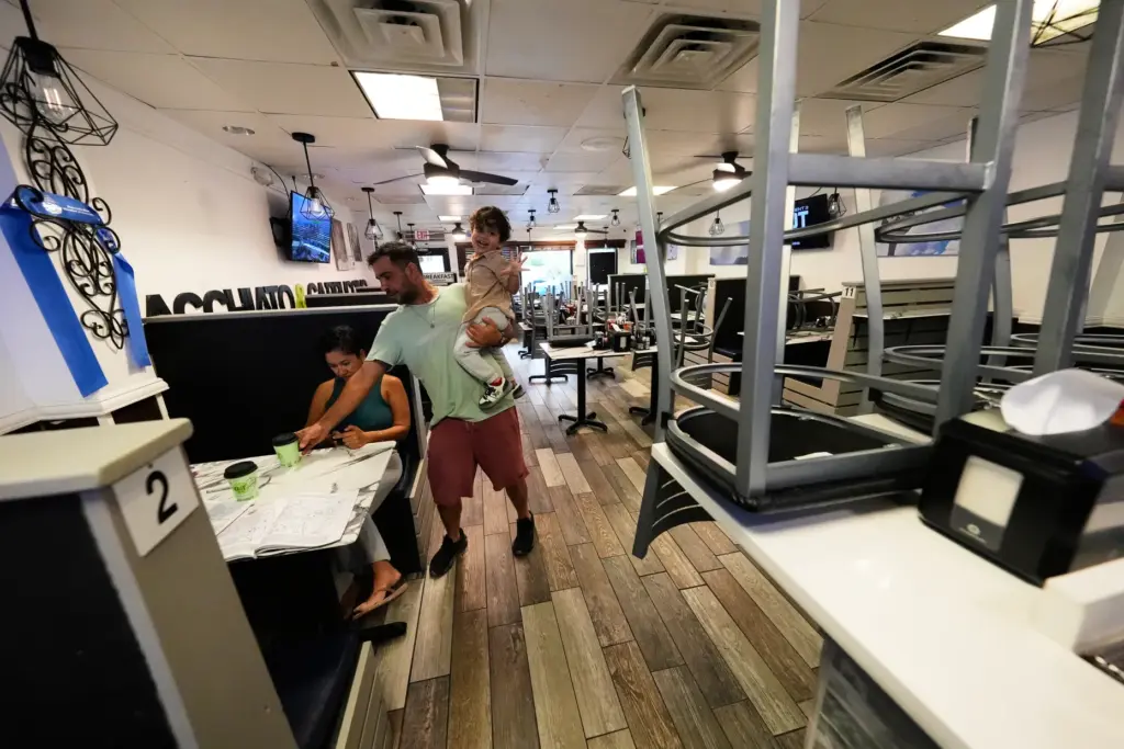 Shahar David, employee at Cafe Bistro, feeds his family before...