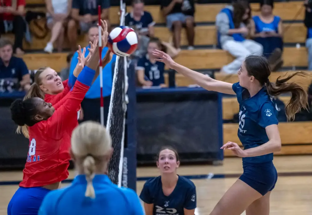 Newport Harbor middle blocker Morgan Starkenburg (15) hits the ball...