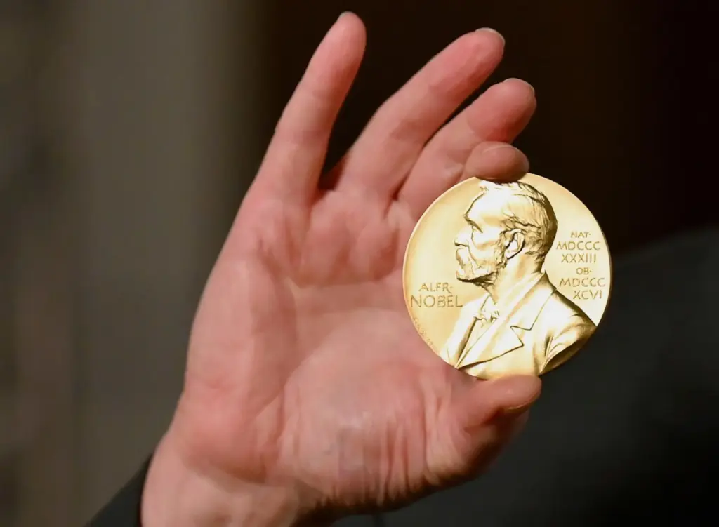 A Nobel medal is held up during a ceremony in New York.