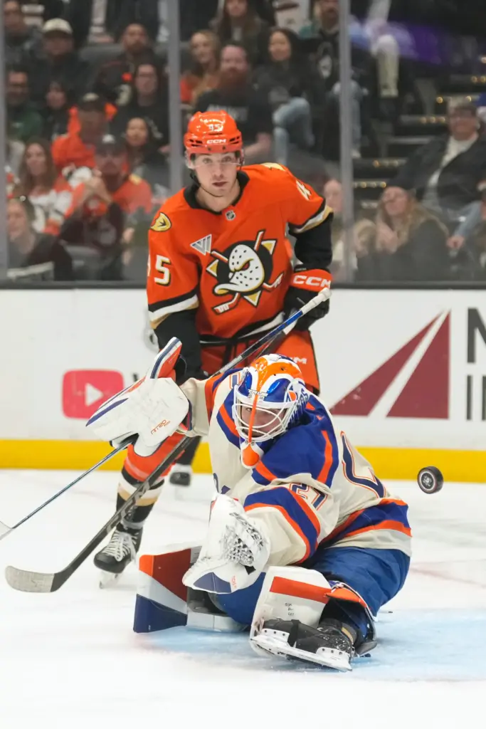 Edmonton Oilers goaltender Devon Levi, below, deflects a shot as...