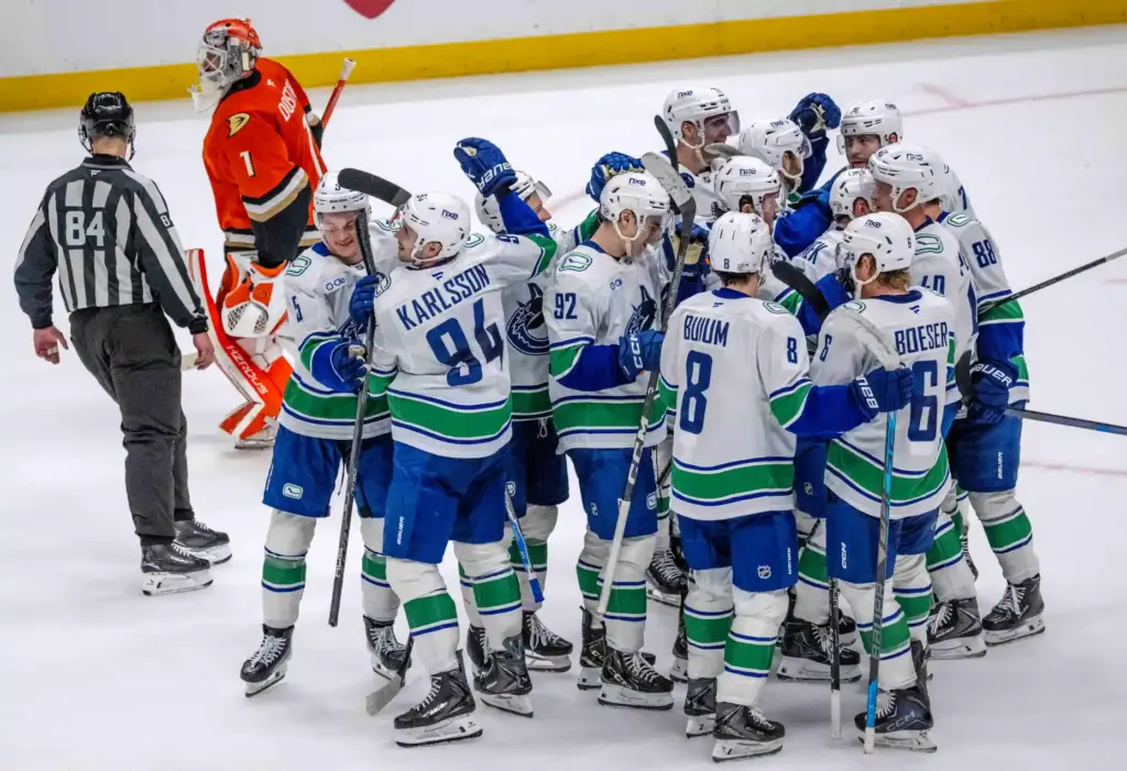 Vancouver Canucks players celebrate after their 6-5 overtime victory over...