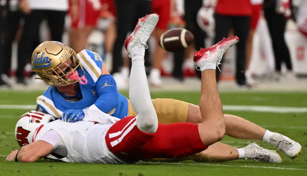 Linebacker Scott Taylor #20 of the UCLA Bruins sacks quarterback...