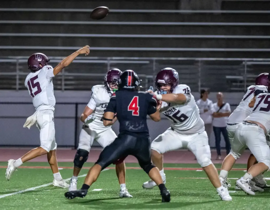 Laguna Beach quarterback Braden Hansen (15) throws the ball during...