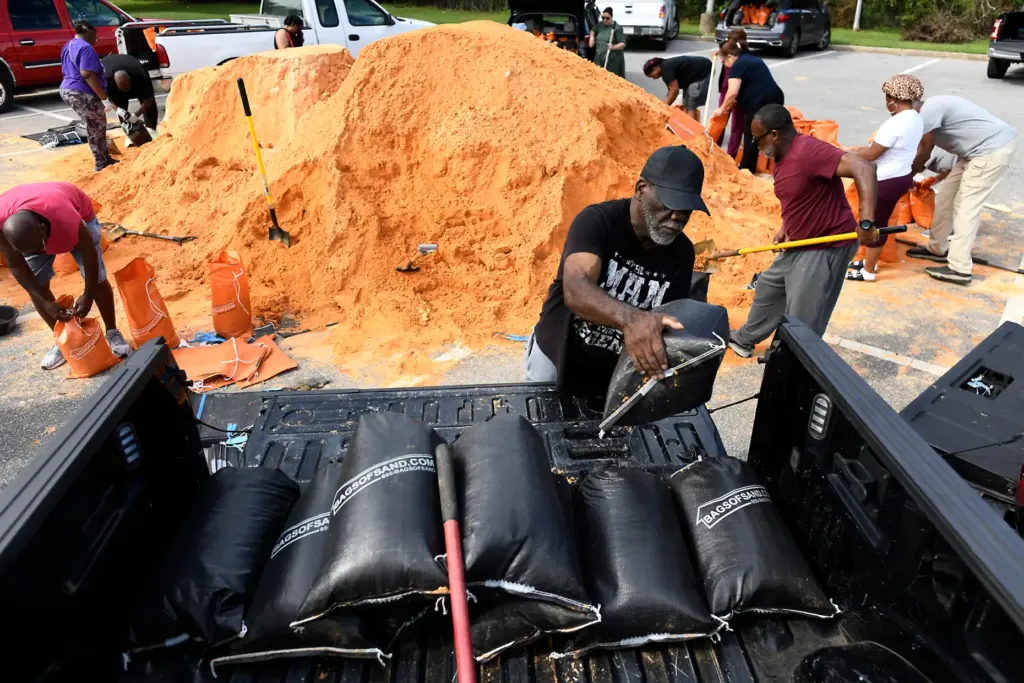 Residents pick up sandbags for storm preparation at the James...
