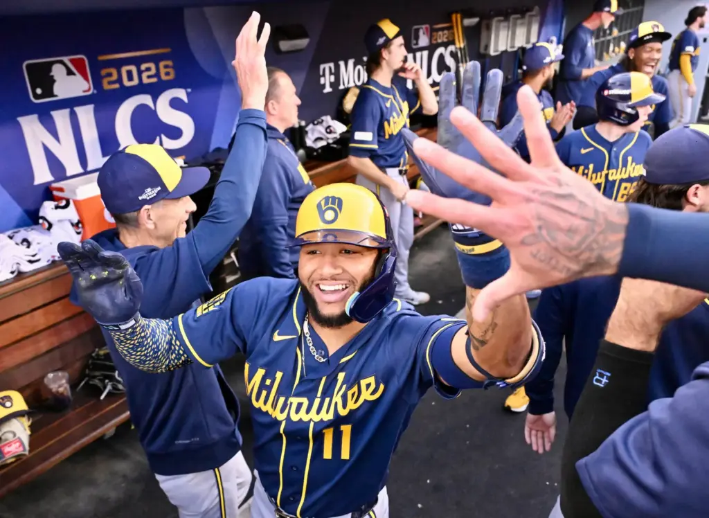The Milwaukee Brewers’ Jackson Chourio celebrates with teammates in the...