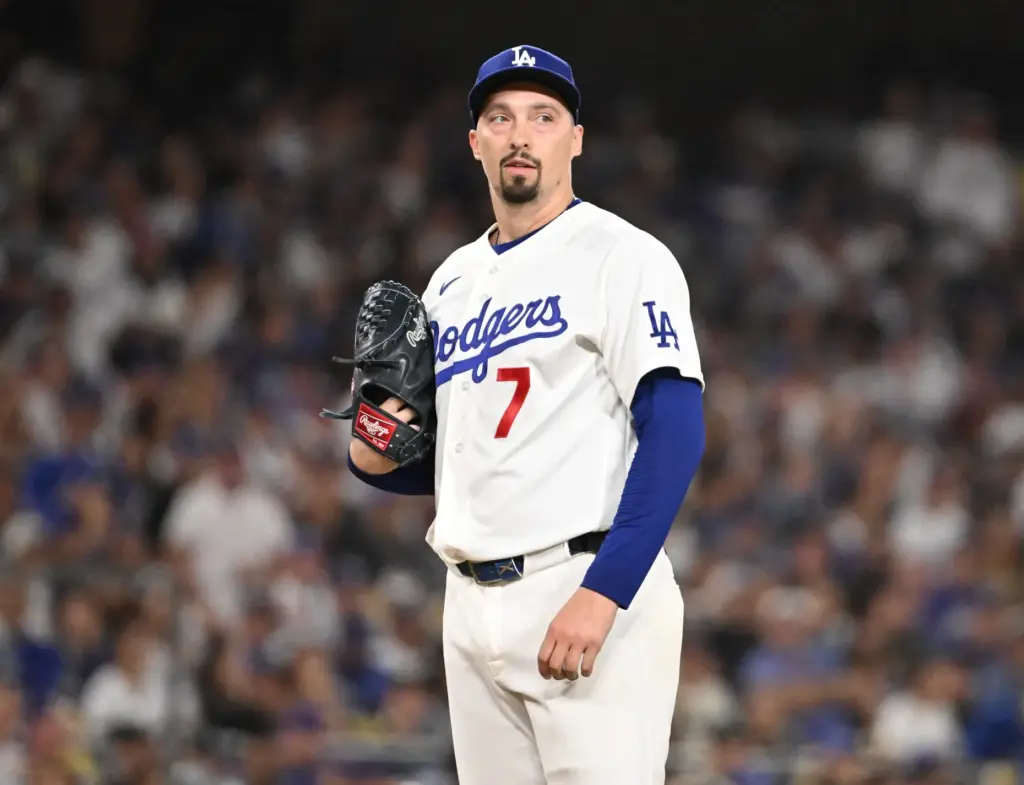 Dodgers starting pitcher Blake Snell looks on after giving up...