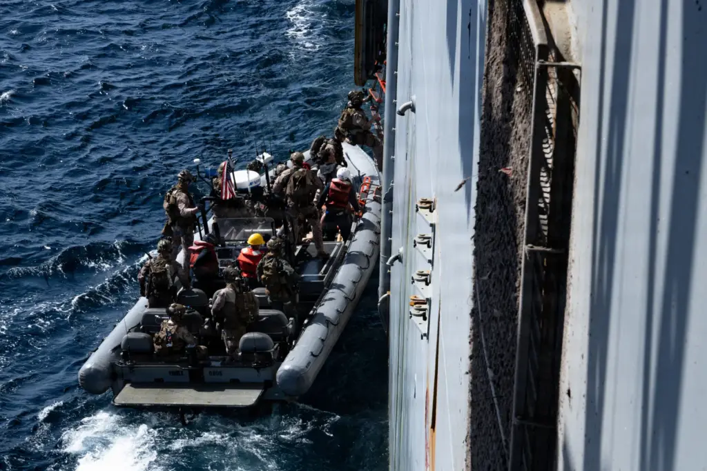 U.S. Marines from the 31st Marine Expeditionary Unit board M/V...