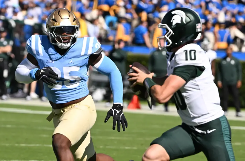 UCLA linebacker Trent Hendrick (25) pressures Michigan State quarterback Kayd...