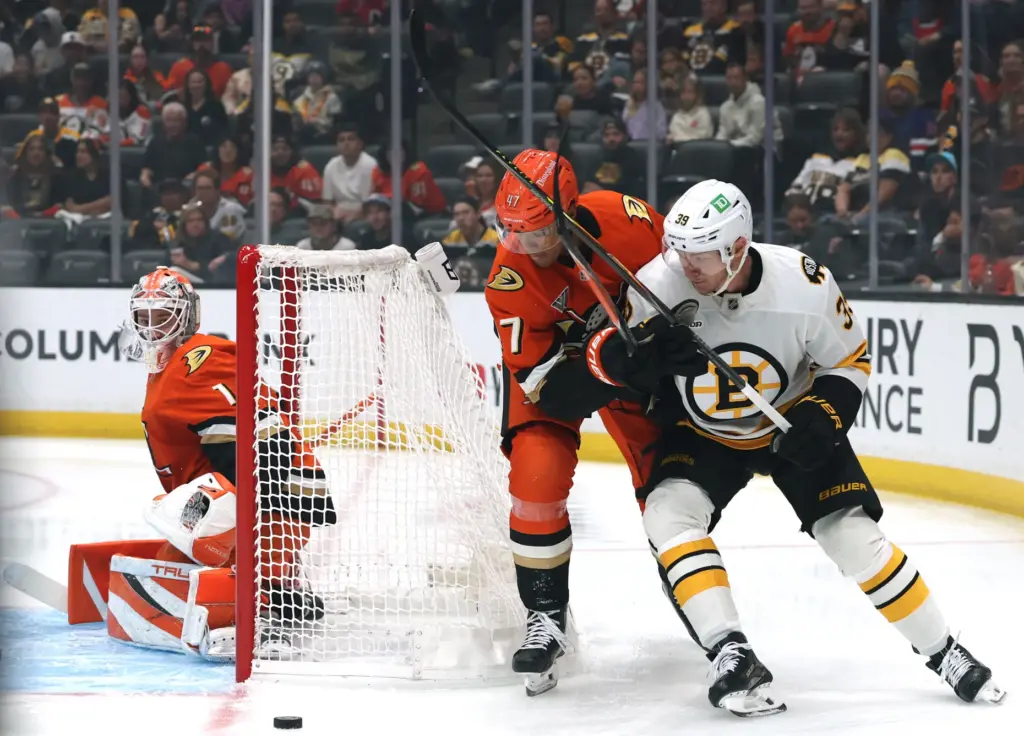 The Boston Bruins’ Morgan Geekie, right, and the Ducks’ Noah...