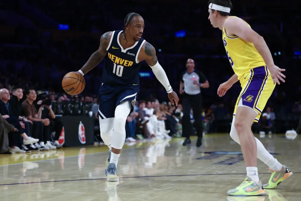 Denver Nuggets guard DeMar DeRozan brings the ball up the...