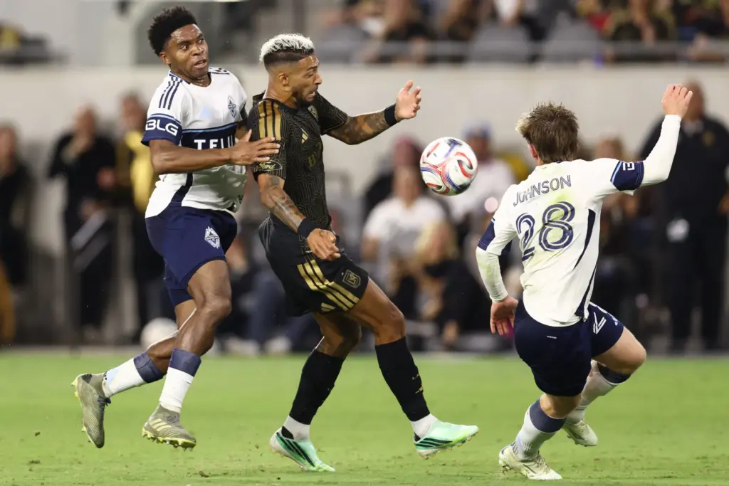 Los Angeles FC forward Denis Bouanga, center, attemps to recover...