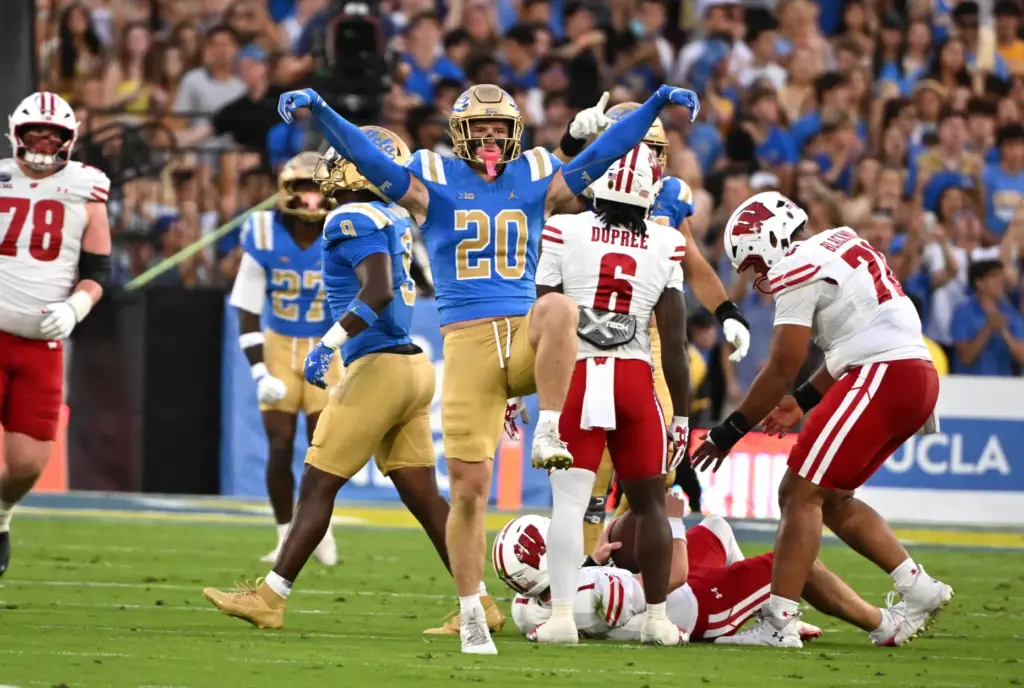 Linebacker Scott Taylor #20 of the UCLA Bruins reacts after...