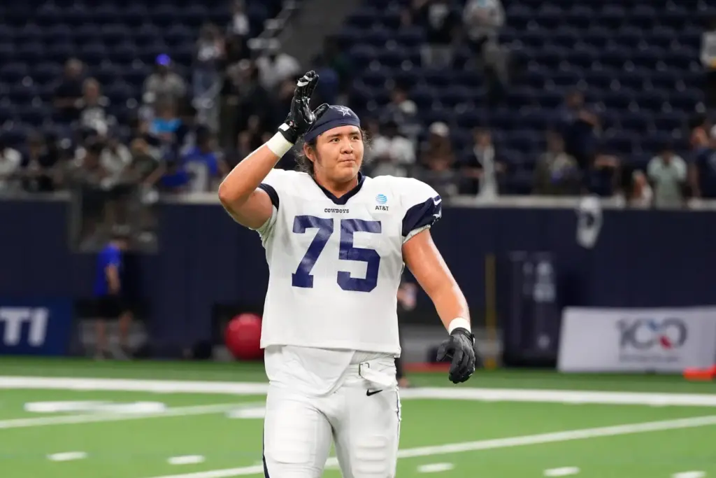 Dallas Cowboys offensive tackle Shiyazh Pete waves to fans after an NFL practice.