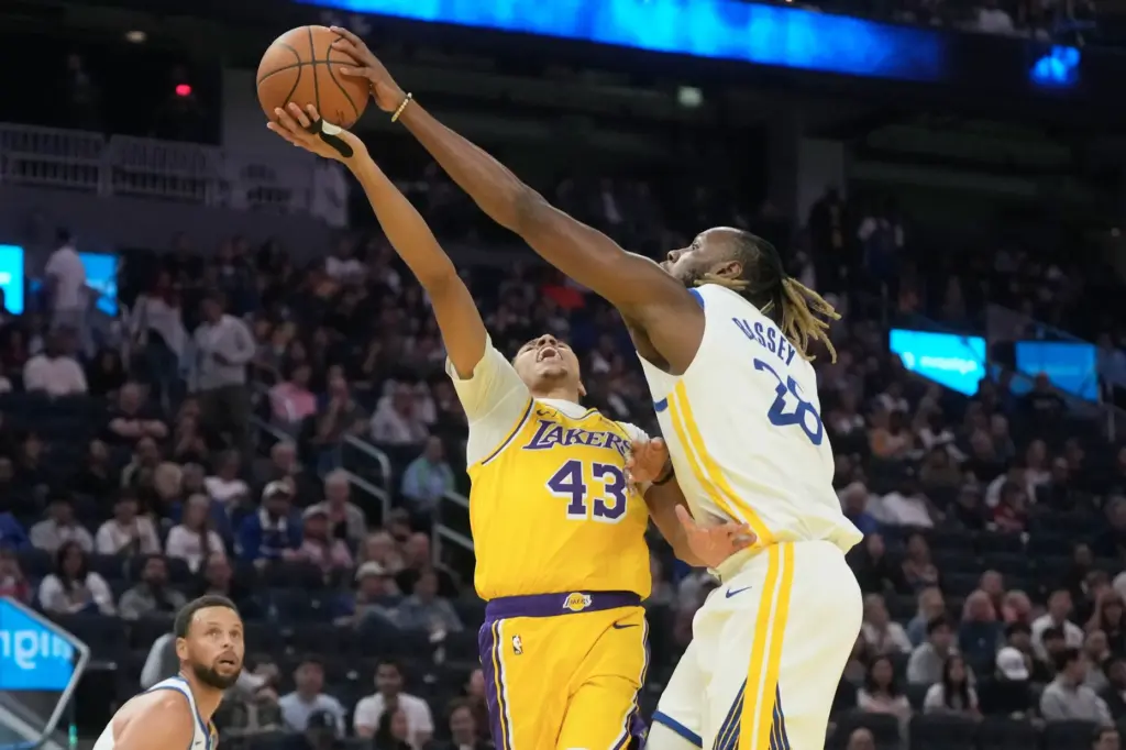 Golden State Warriors center Charles Bassey, right, blocks a shot...