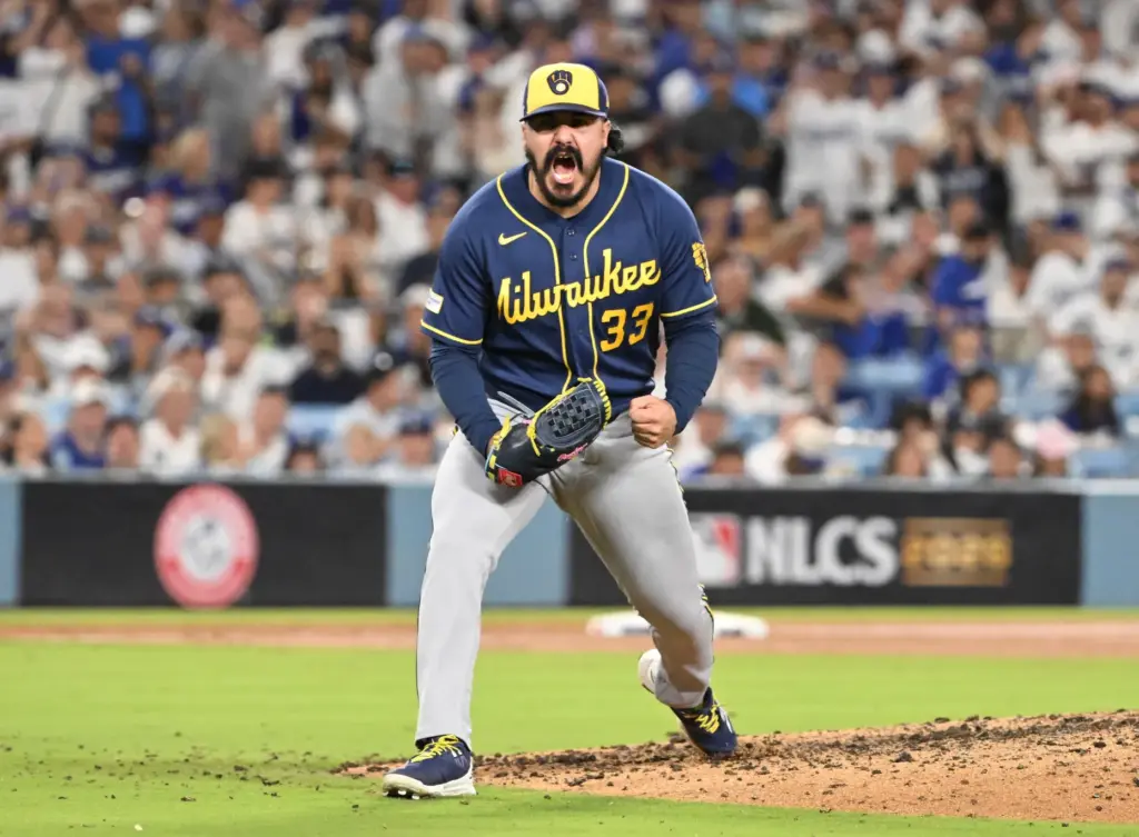 Milwaukee Brewers relief pitcher JoJo Romero reacts after striking out...
