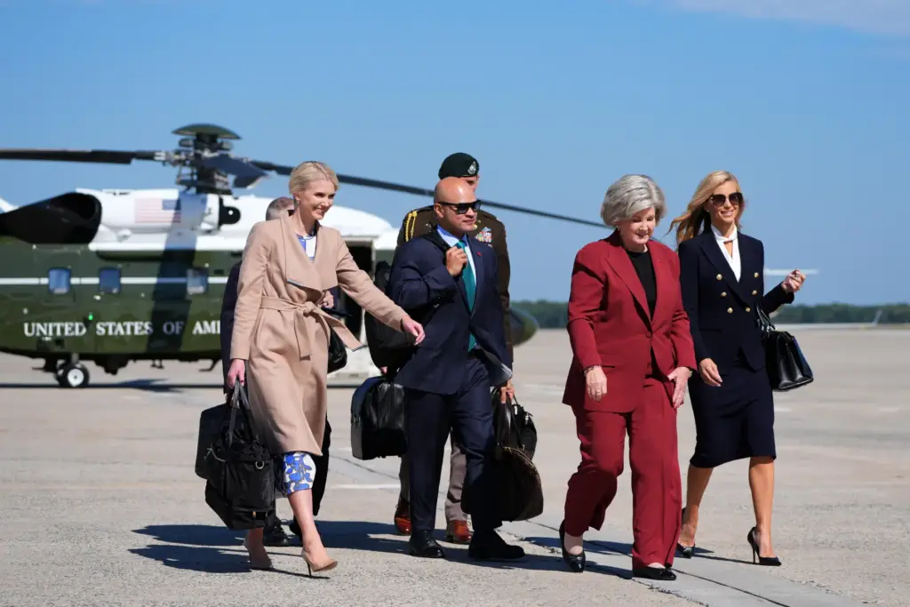 Natalie Harp, Walt Nauta, Susie Wiles and Katie Zacharia walk to board Air Force One.