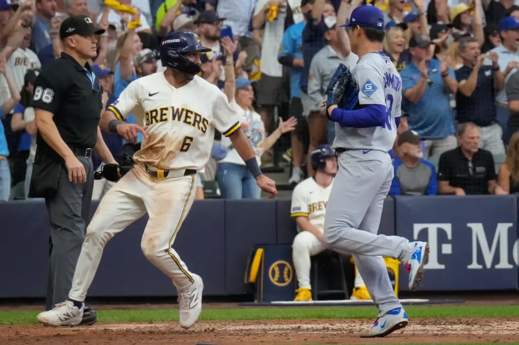 The Milwaukee Brewers’ David Hamilton, left, scores on a two-run...