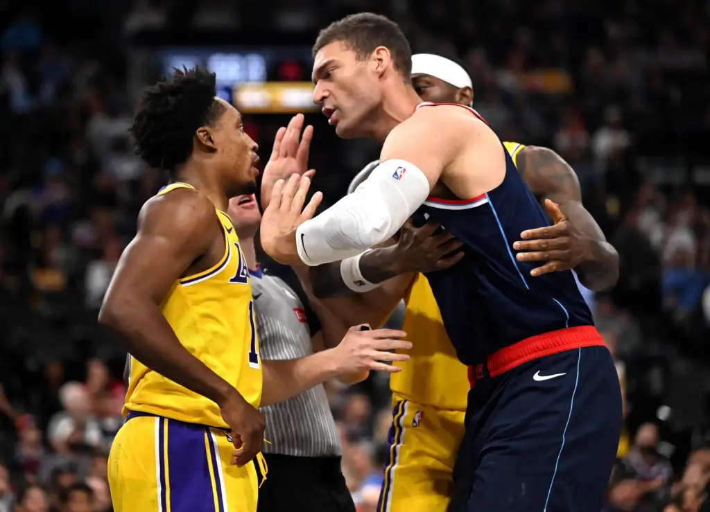 Clippers center Brook Lopez, right, tries to calm Lakers guard...