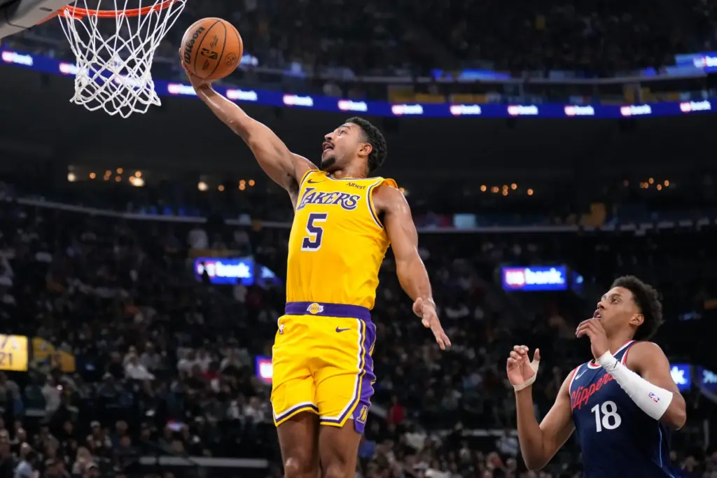Lakers guard Quentin Grimes, left, gets to the basket for...