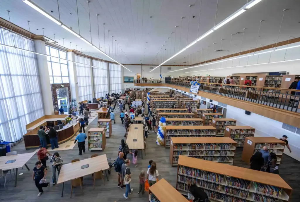 Residents browse bookshelves in the main hall of the Santa...