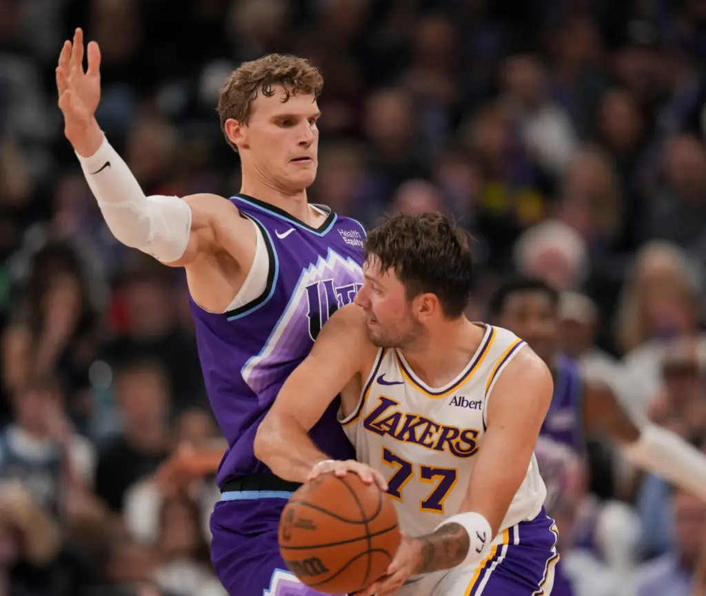 Utah Jazz forward/center Lauri Markkanen, left, blocks as Lakers forward/guard...