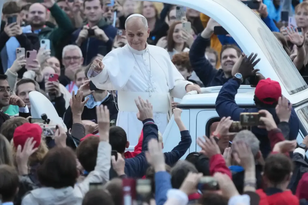 Pope Leo XIV waves as he arrives for his weekly general audience.
