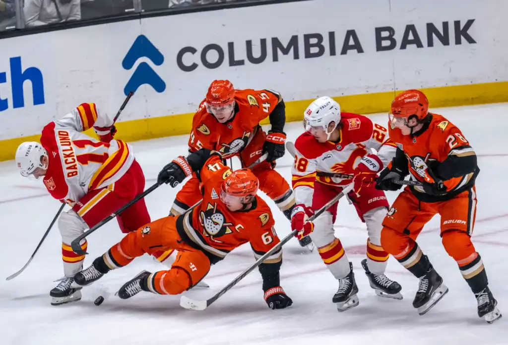 From left, the Calgary Flames’ Mikael Backlund, the Ducks’ Beckett...